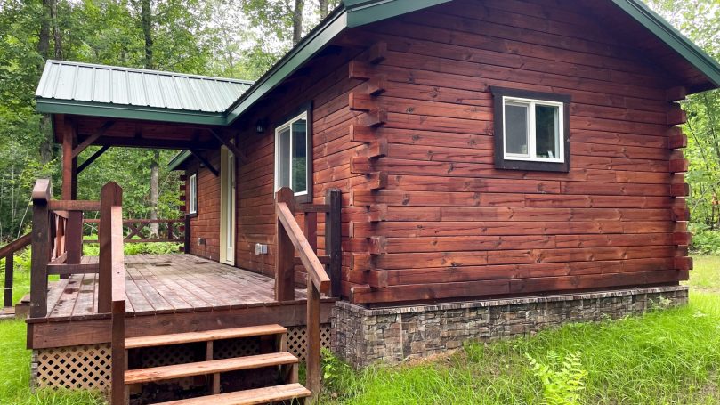 Side view of cabin designed by Rustic Haven Cabins