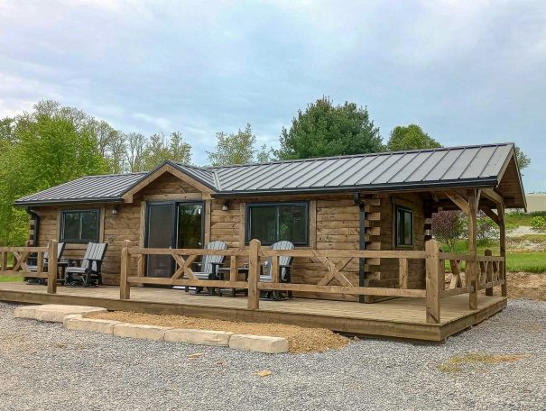 Cabin with wrap around deck, windows, and other custom features.