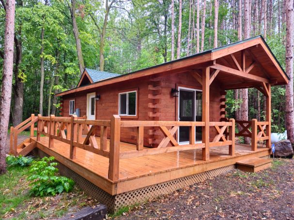 Cabin built by the amish surrounded by trees.